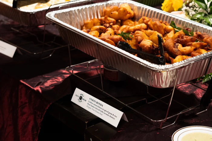 John's South Indian Kitchen onion bonda labeled catering tray display