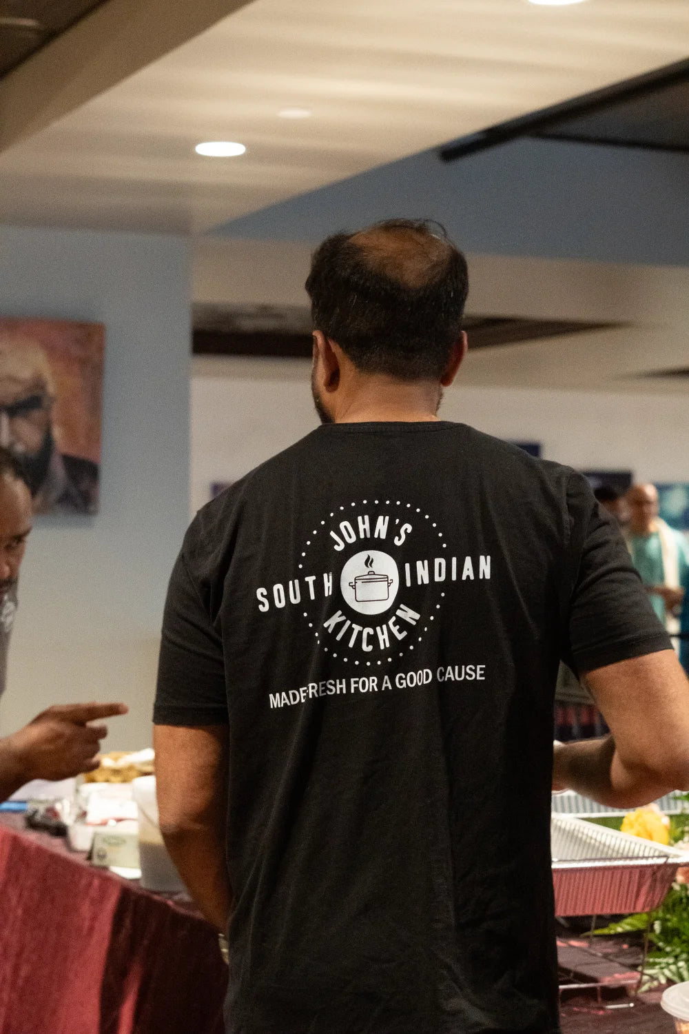 John's South Indian Kitchen staff shirt back catering buffet setup